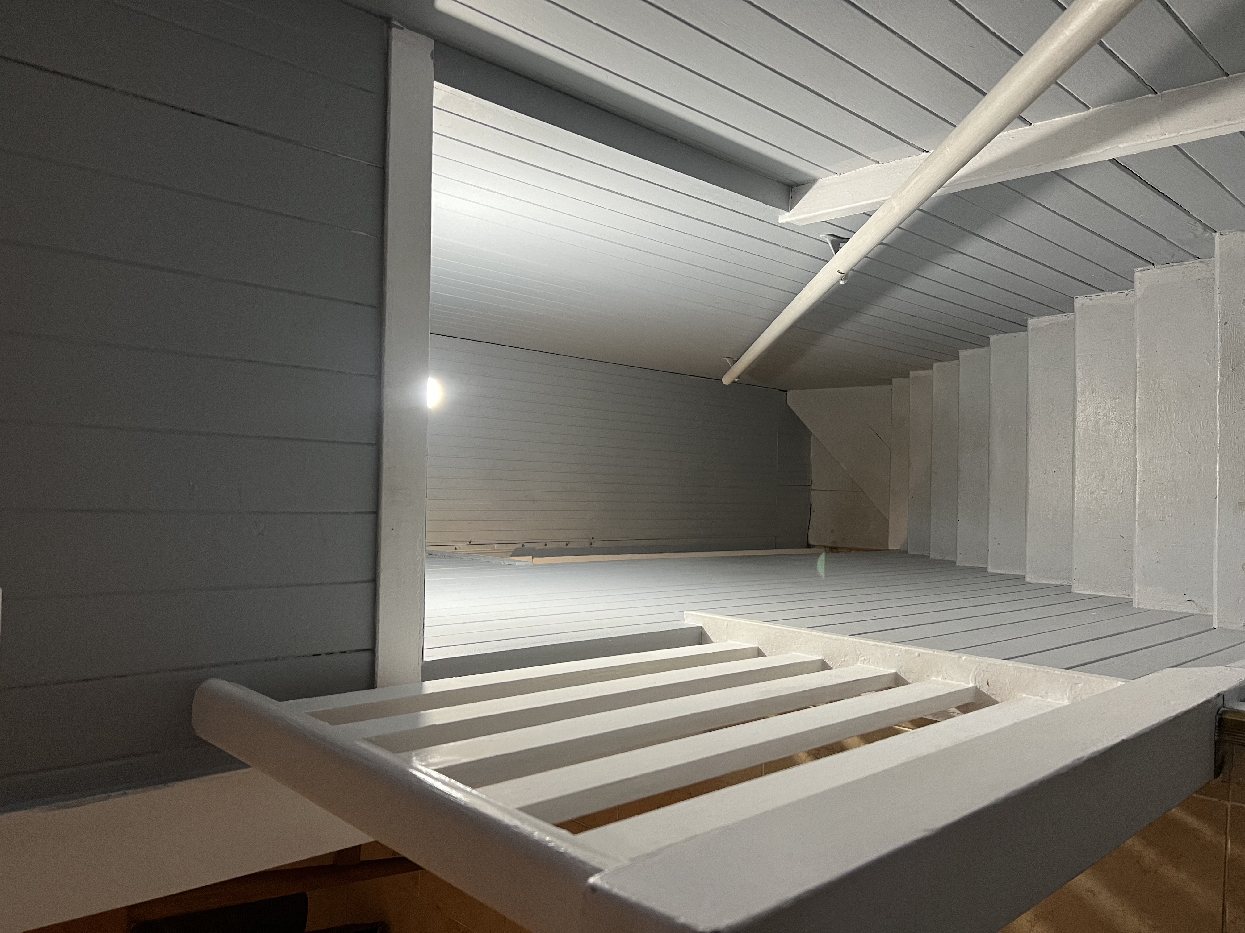long dimly lit white staircase descending down